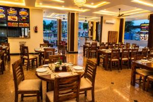 a restaurant with tables and chairs in a room at Hotel Shekhawati Resort -Parking Restaurant Near Toran Dwar in Khātu