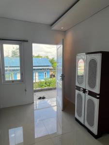 an empty room with a door and a window at hb co living in Tanjungredep +10 photos