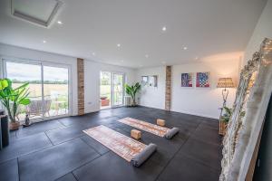 a living room with a large window and a large room with at Toad Hall Lodges - Luxury Glamping Lodges Near Southwold! in Wangford