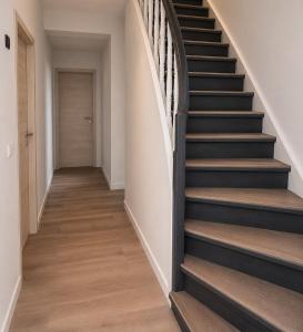 a staircase in a house with black and wood floors at Schuster's Apartments in Augsburg