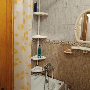 a bathroom with a shower and a sink and a tub at Квартира in Sumy