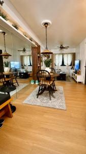 a large living room with a table and chairs at Terravive in Manila
