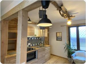a kitchen with a sink and a stove at Appartement chaleureux cité vauban à Briançon in Briançon