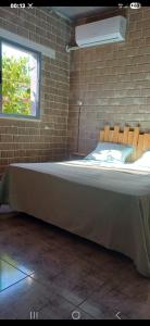 a bed in a room with a brick wall at Caslune in El Bidha +47 photos