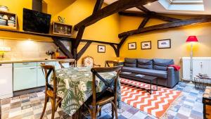 a living room with a table and a couch at Maison Wilson - Dijon centre - very quiet in Dijon