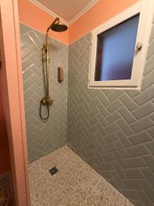 a bathroom with a shower with a window at Nyons Riviera in Nyons