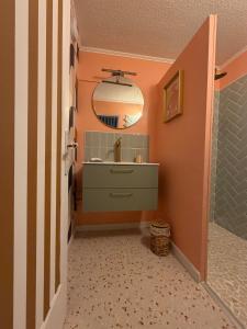 a bathroom with a sink and a mirror at Nyons Riviera in Nyons