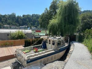 a boat is docked on the side of a road at Donau Vibes Luxury Family near City and Highway in Linz