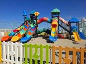 a playground with a colorful slide and slides at Domus Dafne Apartment in Senigallia