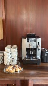 a coffee machine sitting on top of a counter with bread at Hotel Lucija in Most na Soči