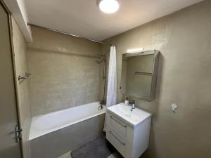 a bathroom with a sink and a tub and a toilet at Villa Leda - The Guest Wing in Paphos +15 photos