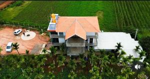 an aerial view of a house with a yard at New Peak By The Lake in Chikmagalūr +17 photos