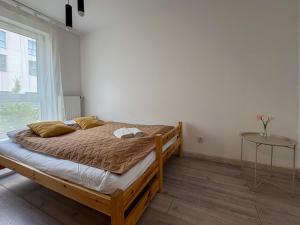 a bedroom with a bed in a room with a window at Apartament Bulwary 7 in Oświęcim