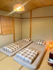 two beds in the corner of a room at Love Kyoto Kyoenkan in Kyoto