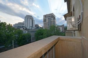 a balcony with a view of a city skyline at Tumanyan Guesthouses in Yerevan