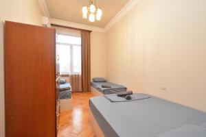 a hospital room with a bed and a door at Tumanyan Guesthouses in Yerevan