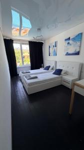 two beds in a large room with two windows at Вілла с басейном in Zatoka