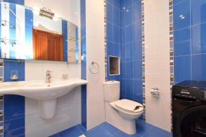 a blue and white bathroom with a toilet and a sink at Tumanyan Guesthouses in Yerevan +37 photos