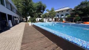 a large swimming pool next to a building at Вілла с басейном in Zatoka +9 photos