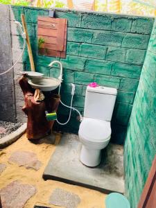 a bathroom with a toilet and a sink at Rooms at Maduka Restaurant in Ilandaiyadi