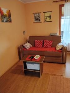 a living room with a couch and a coffee table at Konak kik in Zaovine