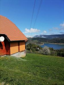 a house on a hill with a view of a lake at Konak kik in Zaovine