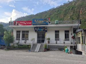 a building on the side of a mountain at K C Hotel & Restaurant in Rudraprayāg +5 photos