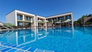 a large swimming pool in front of a building at Hypnose Resort - Adult Only 14 in Vadu