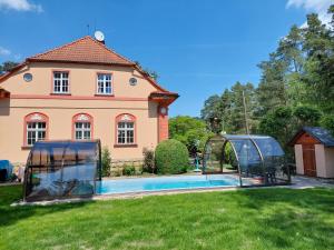 a house and a swimming pool in front of a house at Splavský zámeček in Staré Splavy