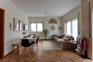 a living room with a couch and a table at Alegria Beach House in Vila do Conde
