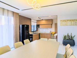 a kitchen and dining room with a table and chairs at Riva guest house in Antananarivo +5 photos