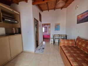 a living room with a couch and a table at Cozy apartment with a great view! R in Metamorfosi +5 photos