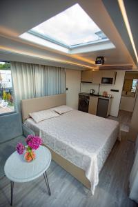 a bedroom with a bed and a table with flowers on it at Mars Oasis Capsule in Charnali