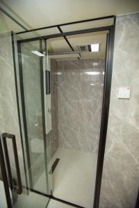 a shower with a glass door in a bathroom at Mars Oasis Capsule in Charnali +23 photos