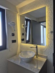 a bathroom with a sink and a mirror at Lumy Suite Hotel Bodrum Gumbet - Private Pool in Bodrum City