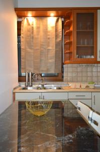 a kitchen with a sink and a bowl on a counter at D6 Lake View in Kastoria +27 photos