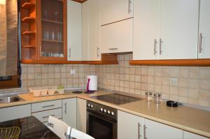 a kitchen with white cabinets and a stove top oven at D6 Lake View in Kastoria