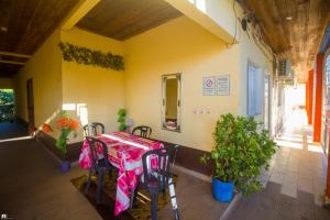 a table and chairs on the porch of a house at Hotel National Ambilobe in Ambilobe