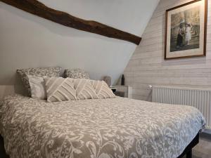 a bedroom with a bed and a picture on the wall at La Maraiquaise in Marais-Vernier +139 photos