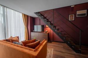 a living room with a couch and a staircase at Inpeng View Hotel in Vientiane