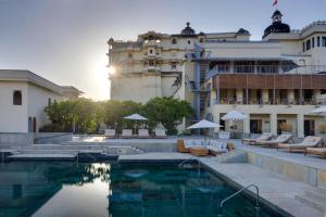 a hotel with a pool in front of a building at RAAS Devigarh in Udaipur