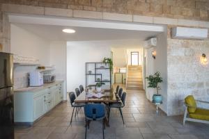 a kitchen and dining room with a table and chairs at Briaa Wellness Resort Hotel Gilboa - Adults Only in Maalé-Hagilbo‘a