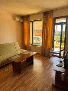 a living room with a couch and a coffee table at Dream Bay Apartments in Tsarevo