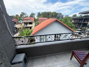 a balcony with a building with an orange roof at Hotel Like Mari in P'ichvnari