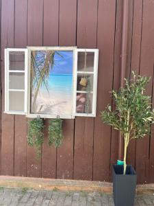 an open window with a view of the beach at Garten Oase Weisweil in Weisweil +10 photos