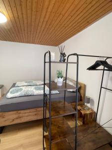 a bedroom with a bed and a wooden ceiling at Garten Oase Weisweil in Weisweil