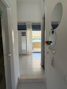a hallway with a mirror and a tile floor at Blu 31 Marcelli in Marcelli