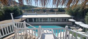 a swimming pool on a deck with a white railing at Hotel Palladium in Monastir