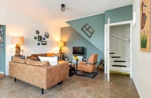 a living room with a couch and a chair at Grytmanshoeve, Vakantiehuis met glamping in Niawier