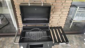 a black grill and a bench in front of a building at Hani's Partyhaus in Verl